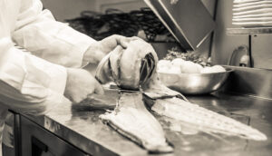 chef preparing fresh fish filets